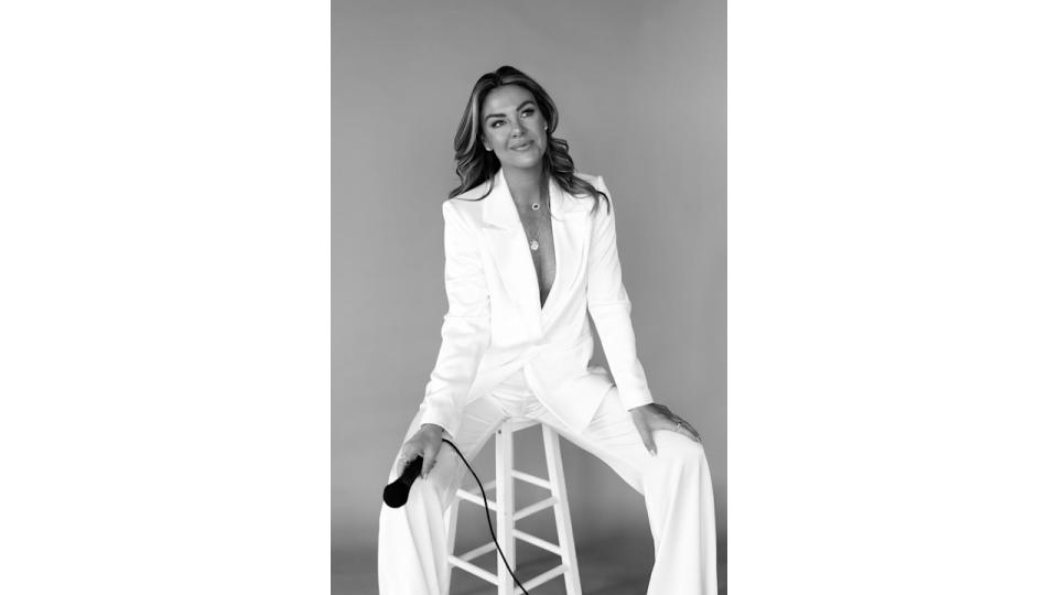 Woman in black and white wearing a white suit