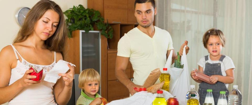 Sad woman with receipt from store, family brought food home. Focus on woman