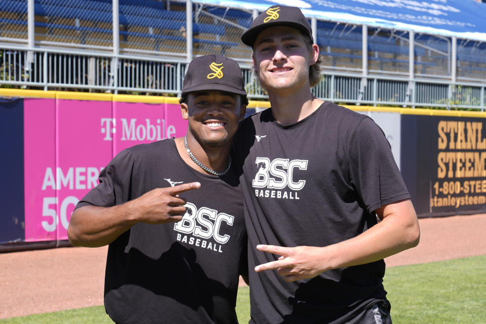 Birmingham-Southern pitchers Jacob Fields, left, and Charlie Horne, right, pose for a photo during a practice Thursday, May 30, 2024, in Eastlake, Ohio. On Friday, the Panthers will continue an unexpected, uplifting season that has captured hearts across the country by playing in the Division III World Series on the same day the liberal arts college founded on the eve of the Civil War shuts its doors. (AP Photo/Sue Ogrocki)
