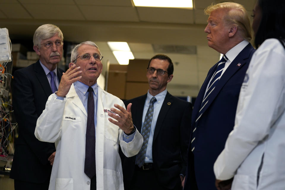 President Donald Trump listens as he tours the Viral Pathogenesis Laboratory at the National Institutes of Health, Tuesday, March 3, 2020, in Bethesda, Md. (AP Photo/Evan Vucci)