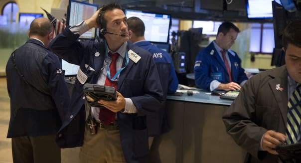 Traders work on the floor of the New York Stock Exchange (NYSE) in New York, U.S., on Wednesday, July 31, 2013. U.S. stocks erased an earlier rally after the Federal Reserve refrained from indicating when it will reduce the pace of stimulus and data showed the economy grew more than projected in the second quarter. Photographer: Scott Eells/Bloomberg via Getty Images