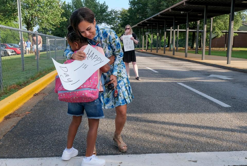 Second grader Oniah Gwyn hugs Tuscaloosa Magnet Elementary Principal Preeti Nichani as she arrives for the first day of classes. Schools opened in both Tuscaloosa City and Tuscaloosa County Wednesday, Aug. 9, 2023.