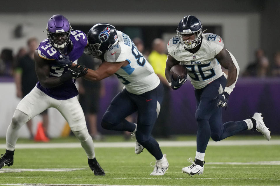 Tennessee Titans running back Julius Chestnut (36) finds running behind tight end Thomas Odukoya (89) who defends against pressure on the play from Minnesota Vikings linebacker Abraham Beauplan (39) in the second half of a preseason NFL football game, Saturday, Aug. 19, 2023, in Minneapolis. (AP Photo/Charlie Neibergall)