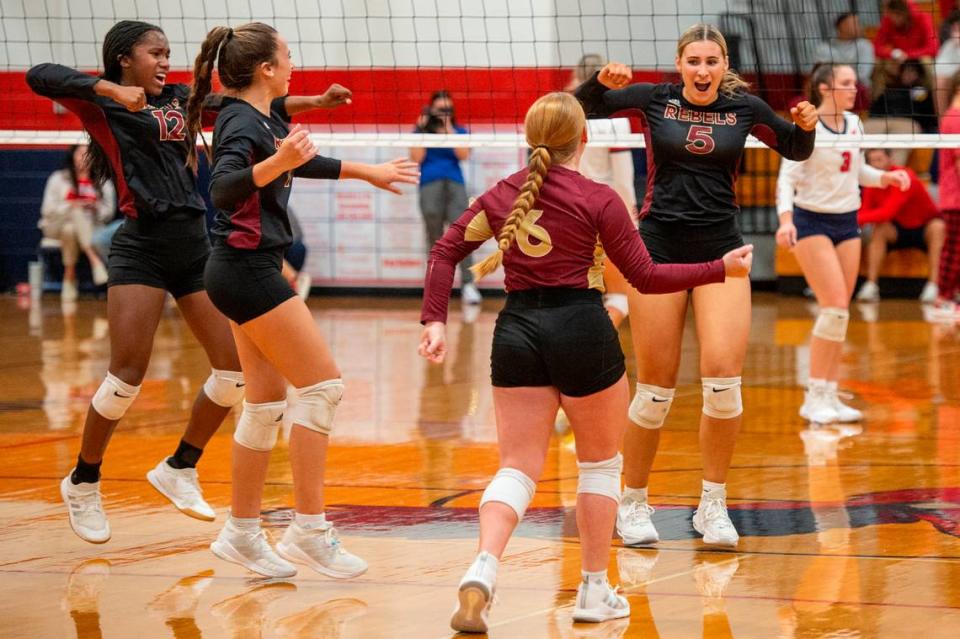 The George County Rebels volleyball team celebrates after a point during the 6A South State Championship game at Hancock High School in Kiln on Monday, Oct. 16, 2023.