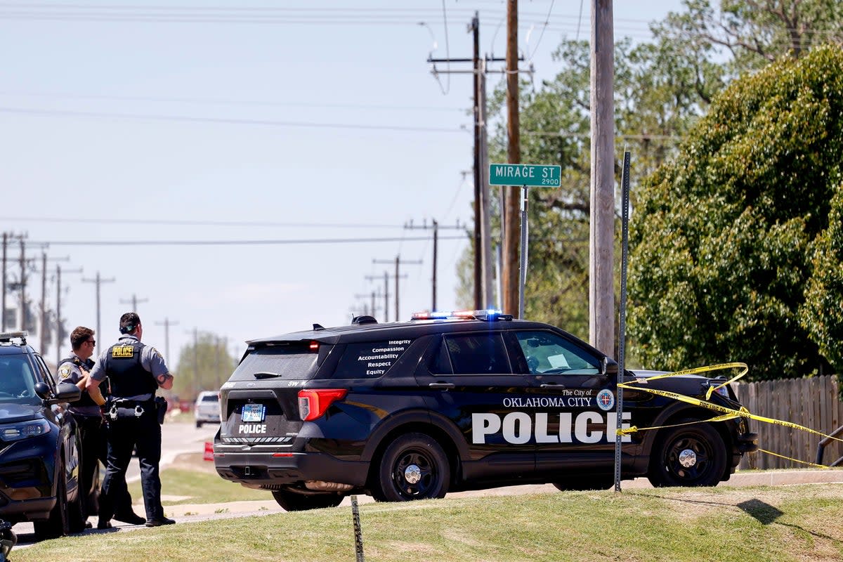 Police investigate after five people were found dead in a home in Oklahoma City on Monday (AP)