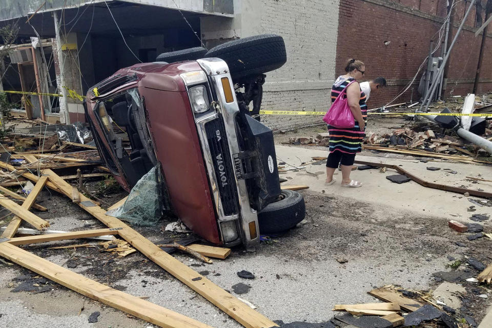A car lies on its side after being knocked over during a tornado that tore through downtown Sulphur, Okla., Sunday, April 28, 2024. (AP Photo/Ken Miller)
