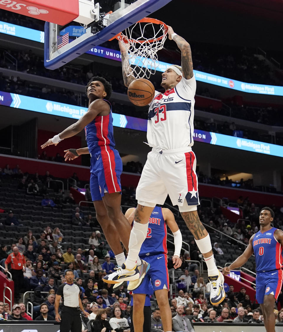 Washington Wizards forward Kyle Kuzma (33) dunks during the first half of an NBA basketball game against the Detroit Pistons, Monday, Nov. 27, 2023, in Detroit. (AP Photo/Carlos Osorio)