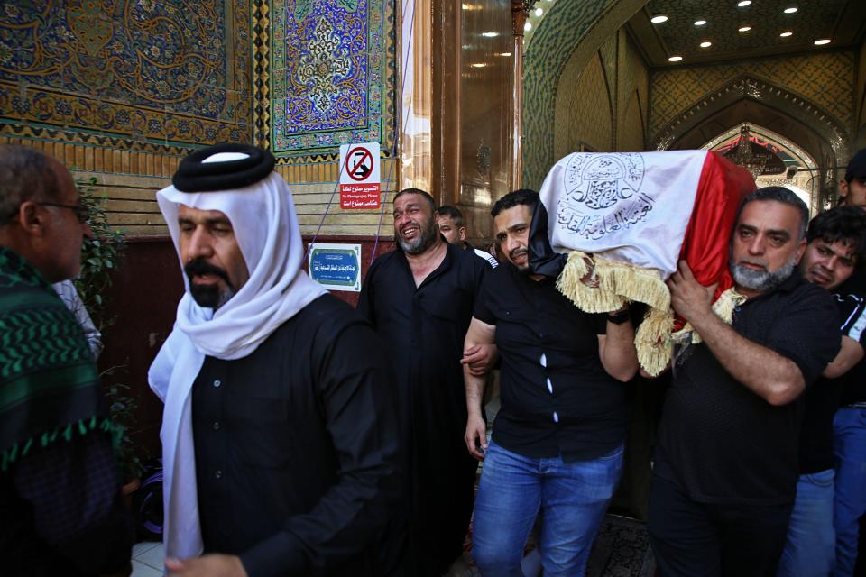 Mourners carry the flag-draped coffin of a protester killed during anti-government protesters during his funeral at the Imam Ali shrine in Najaf, Iraq, Saturday, Oct. 5, 2019. The spontaneous protests which started Tuesday in Baghdad and southern cities were sparked by endemic corruption and lack of jobs. Security responded with a harsh crackdown, leaving more than 70 killed. (AP Photo/Anmar Khalil)