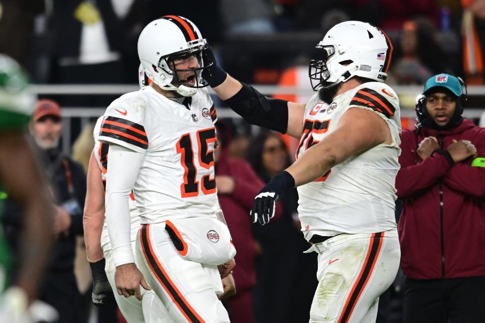 Cleveland Browns quarterback Joe Flacco (15) celebrates with guard Joel Bitonio (75) after a touchdown pass against the New York Jets during the first half at Cleveland Browns Stadium.
