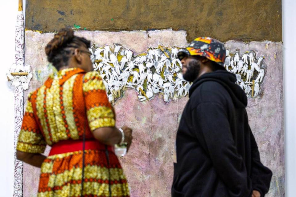 People socialize and view artwork during the Preview for The Art of Transformation event at The ARC and Logan Building in Opa-locka.