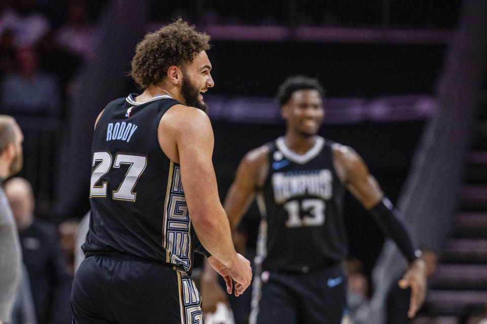 Memphis Grizzlies forward David Roddy (27) laughs as he heads off for a timeout during the first half of an NBA basketball game against the Charlotte Hornets on Wednesday, Jan. 4, 2023, in Charlotte, N.C. (AP Photo/Scott Kinser)