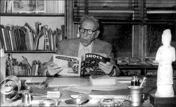 Dr. Frederic Wertham reading a comic book at his desk. In 1954, the New York psychiatrist gave Senate testimony blaming horror and superhero comics for a rise in juvenile delinquency.