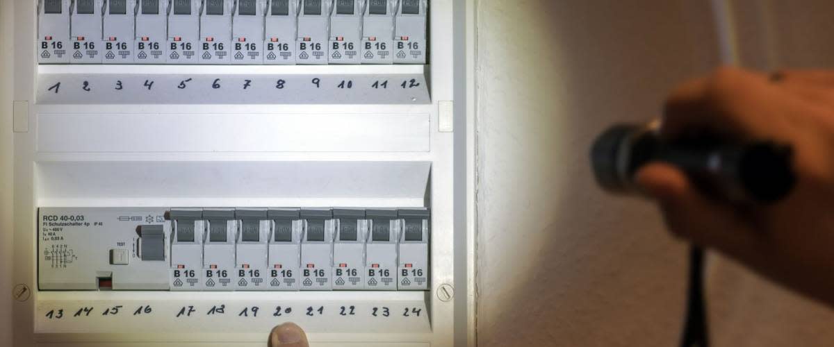 Fuse box illuminated with a flashlight in case of power failure