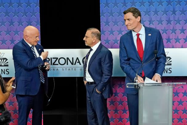 PHOTO: Arizona Democratic Sen. Mark Kelly, left, talks with Libertarian candidate Marc Victor, middle, and Republican candidate Blake Masters, right, prior to a televised debate in Phoenix, Oct. 6, 2022. (Ross D. Franklin/AP)