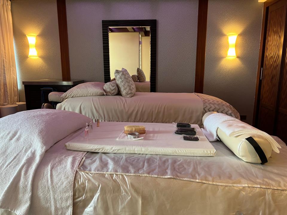 Two spa beds in a dimly lit room. 