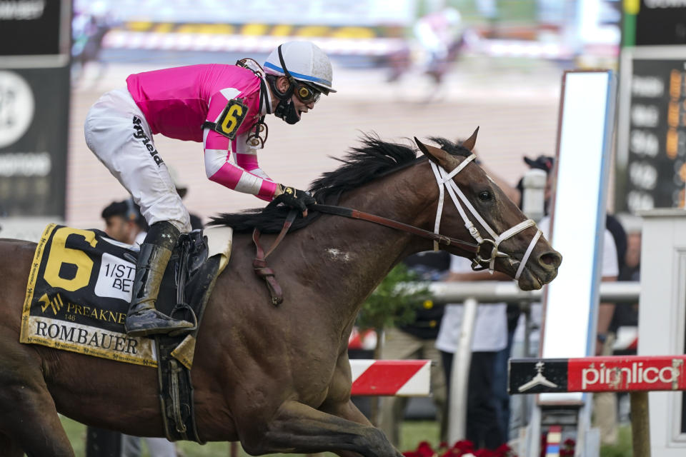 Flavien Prat atop Rombauer reacts as he crosses the finish line to win the Preakness Stakes horse race at Pimlico Race Course, Saturday, May 15, 2021, in Baltimore. (AP Photo/Julio Cortez)