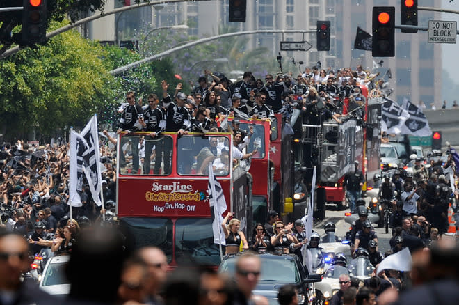 LOS ANGELES, CA - JUNE 14: Bus with Los Angeles Kings team members and their families travels down Figueroa Street to the Staples Center during the Stanley Cup victory parade on June 14, 2012 in Los Angeles, California. The Kings are celebrating their first NHL Championship in the team's 45-year-old franchise history. (Photo by Kevork Djansezian/Getty Images)