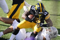 Iowa running back Tyler Goodson (15) is tackled by Northwestern defensive end Earnest Brown IV during the first half of an NCAA college football game, Saturday, Oct. 31, 2020, in Iowa City, Iowa. (AP Photo/Charlie Neibergall)