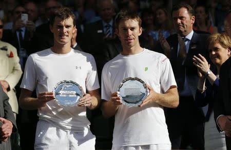 Jamie Murray of Britain and John Peers of Australia (R) show their trophies after losing their Men's Doubles Final match against Horia Tecau of Romania and Jean-Julien Rojer of the Netherlands as Scotland's First Minister Nicola Sturgeon (R) claps at the Wimbledon Tennis Championships in London, July 11, 2015. REUTERS/Suzanne Plunkett