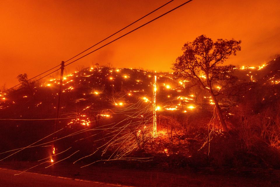 Embers burn along a hillside as the LNU Lightning Complex Fire tears through unincorporated Napa County, Calif., on Aug. 18.