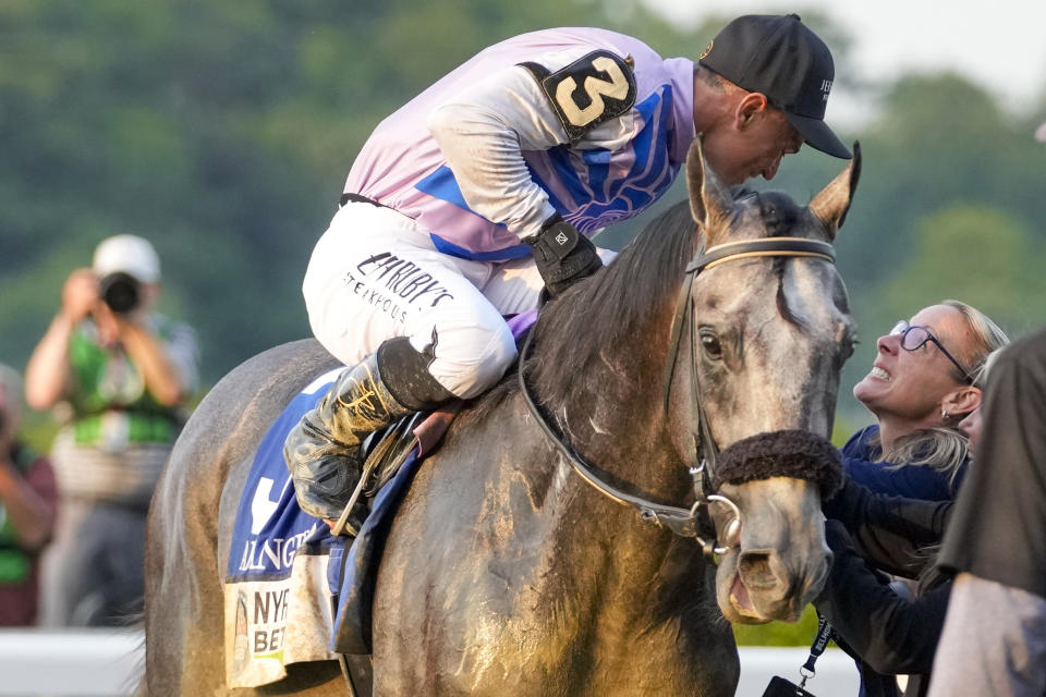 Trainer Jena Antonucci, right, congratulates jockey Javier Castellano, aboard Arcangelo, as they celebrate after winning the 155th running of the Belmont Stakes horse race, Saturday, June 10, 2023, at Belmont Park in Elmont, N.Y. (AP Photo/Mary Altaffer)