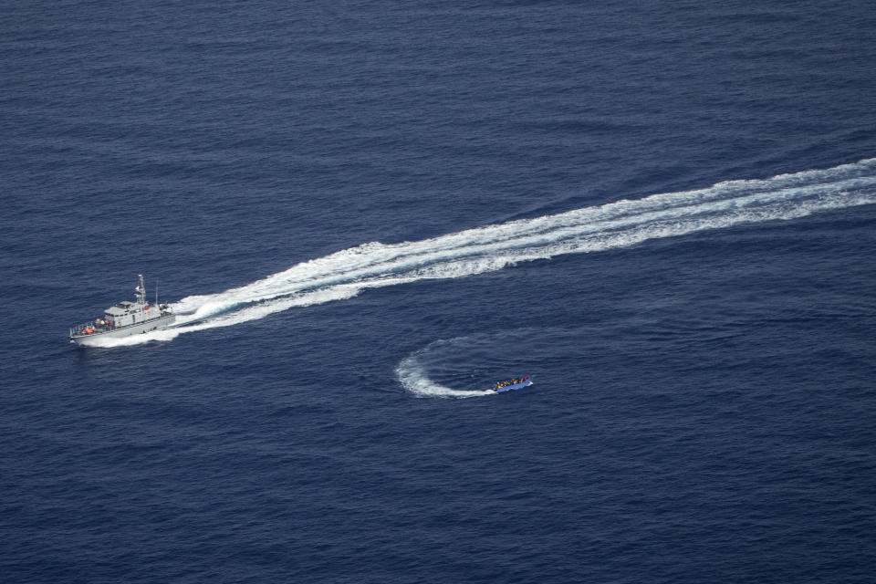 An overcrowded migrant boat, bottom, tries to escape from the Libyan Coast Guard in the Mediterranean Sea, Wednesday, June 30, 2021. A non-profit sea rescue group is denouncing the Libyan Coast Guard and the European Union after it witnessed and filmed the Libyan maritime authorities chasing a crowded migrant boat and shooting in its direction as it tried to stop it from crossing the Mediterranean Sea to Europe. The video was filmed Wednesday by members of Sea-Watch as they flew over the Central Mediterranean during an observation mission and caught the incident on camera from their plane. (Sea-Watch.org via AP)