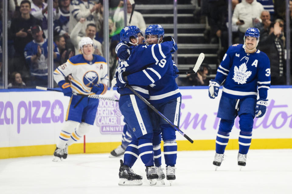 Toronto Maple Leafs center Calle Jarnkrok (19) and right wing Mitchell Marner celebrate Marner's goal against the Buffalo Sabres during the first period of an NHL hockey game Saturday, Nov. 4, 2023, in Toronto. (Christopher Katsarov/The Canadian Press via AP)