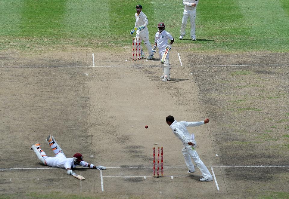 West Indies cricketer Carlton Baugh (L) gets run out during the second day of the first-of-three Test matches between Australia and West Indies at the Kensington Oval stadium in Bridgetown on April 8, 2012. AFP PHOTO/Jewel Samad (Photo credit should read JEWEL SAMAD/AFP/Getty Images)