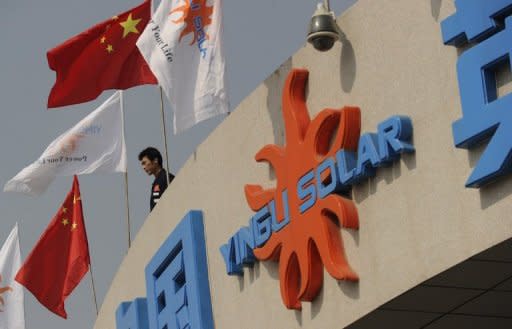 A worker stands on top of the entrance to the Yingli Solar factory, a leading solar energy company and one of the world's largest manufacturers of solar panels, in Baoding, Hebei province in 2010. China Wednesday sought to defuse a trade row with the United States after the latter imposed duties on Chinese solar products, saying it would not hurt ties, even as state media cried protectionism