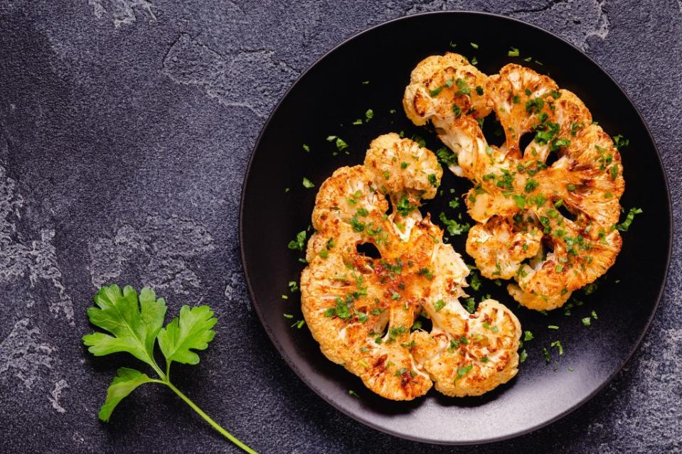 A vegetarian Christmas meal of cauliflower steaks will brighten the holiday. (Adobe Stock)