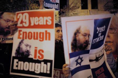 Israelis hold placards depicting Jonathan Pollard during a protest calling for his release from a U.S. prison, outside U.S. Secretary of State John Kerry's hotel in Jerusalem in this file photo froim January 2, 2014. REUTERS/Ammar Awad/Files