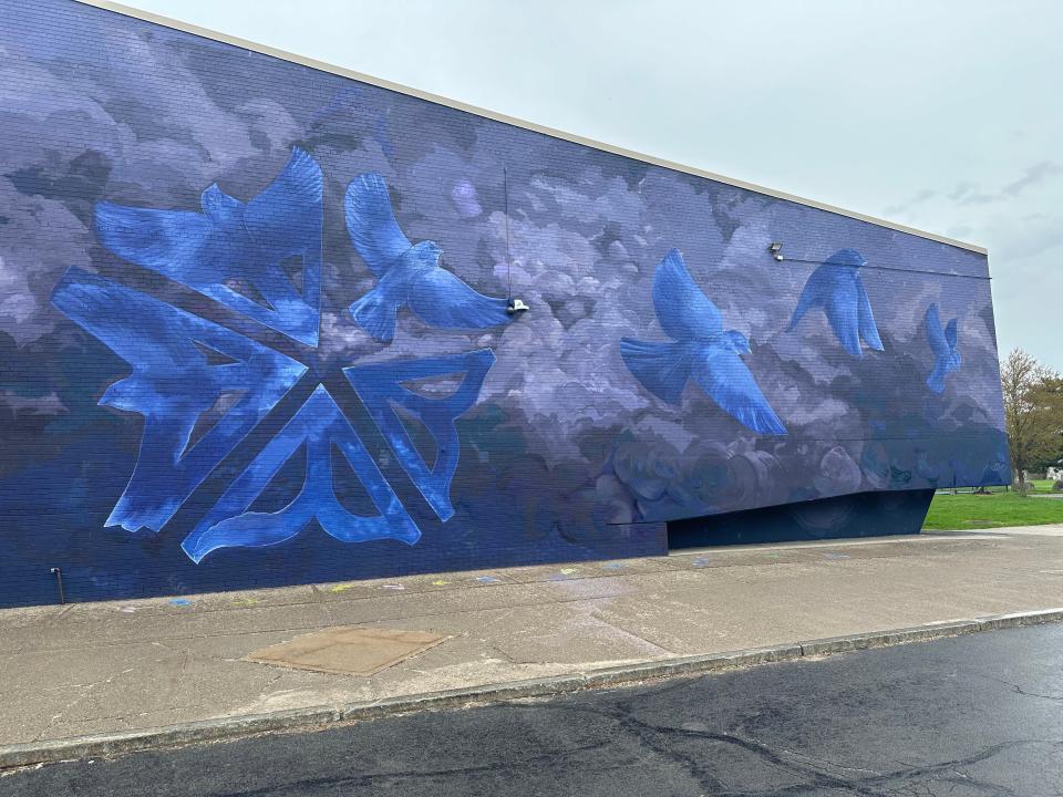 The mural of the front wall of the Edgerton R-Center now welcomes visitors with a unique take on the Rochester logo and birds taking flight on a stunning shades of blues and grays.