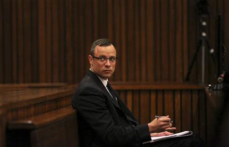 Olympic and Paralympic track star Oscar Pistorius sits in the dock during his trial for the murder of his girlfriend Reeva Steenkamp, at the North Gauteng High Court in Pretoria March 25, 2014. REUTERS/Siphiwe Sibeko/POOL