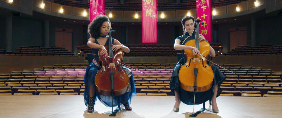 Two women playing cellos