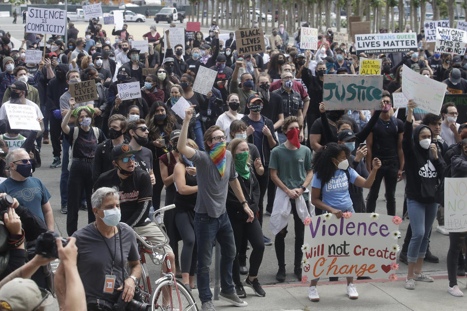 People listen to speakers at a protest over the Memorial Day death of George Floyd, a handcuffed black man in police custody in Minneapolis, in San Francisco, Saturday, May 30, 2020. (AP Photo/Jeff Chiu)