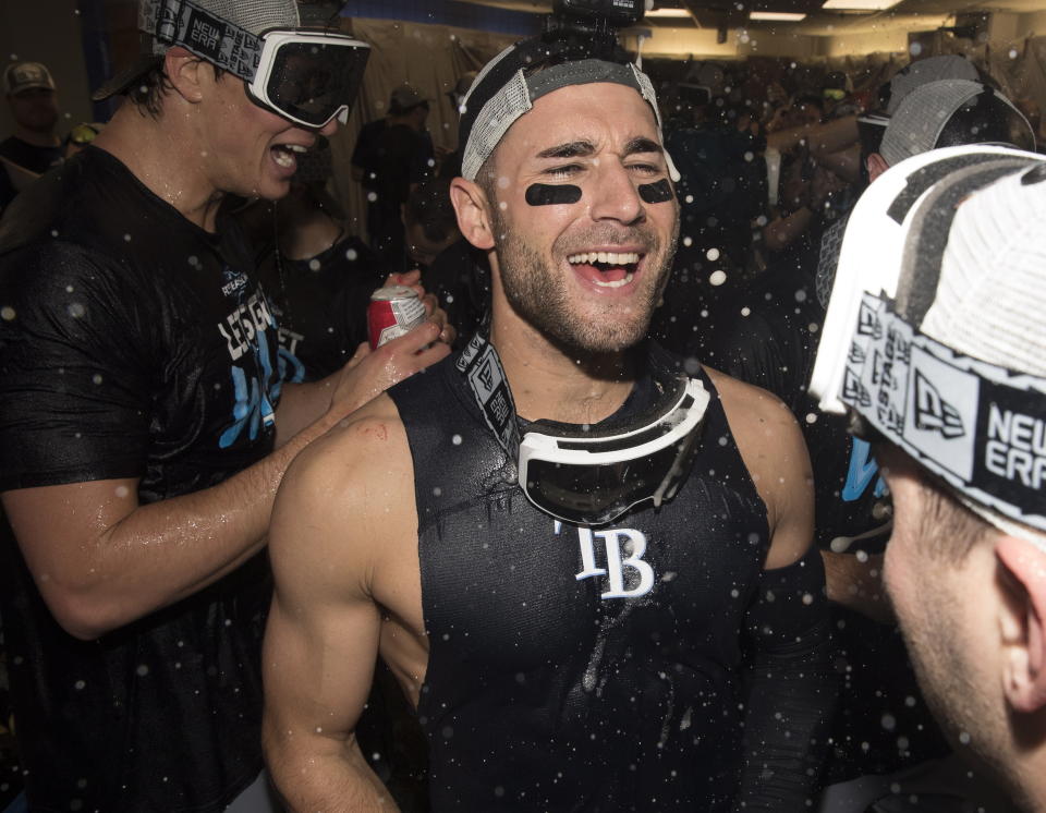 Tampa Bay Rays' Kevin Kiermaier celebrates in the clubhouse after the team defeated the Toronto Blue Jays and clinched an MLB American League wild-card berth in Toronto, Friday, Sept. 27, 2019. (Fred Thornhill/The Canadian Press via AP)