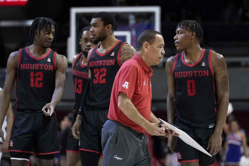 Houston coach Kelvin Sampson, front, walks off the court past Tramon Mark (12), J'Wan Roberts (13), Reggie Chaney (32) and Marcus Sasser (0) after drawing up a play late in the second half of the team's NCAA college basketball game against SMU, Thursday, Feb. 16, 2023, in Dallas. (AP Photo/Tony Gutierrez)