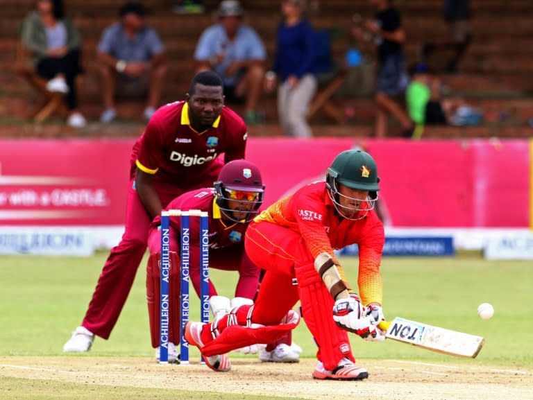 Zimbabwe's batsman Craig Ervine (right) plays a shot during the third tri-nation One Day International (ODI) match between Zimbabwe and West Indies in Bulawayo on November 19, 2016