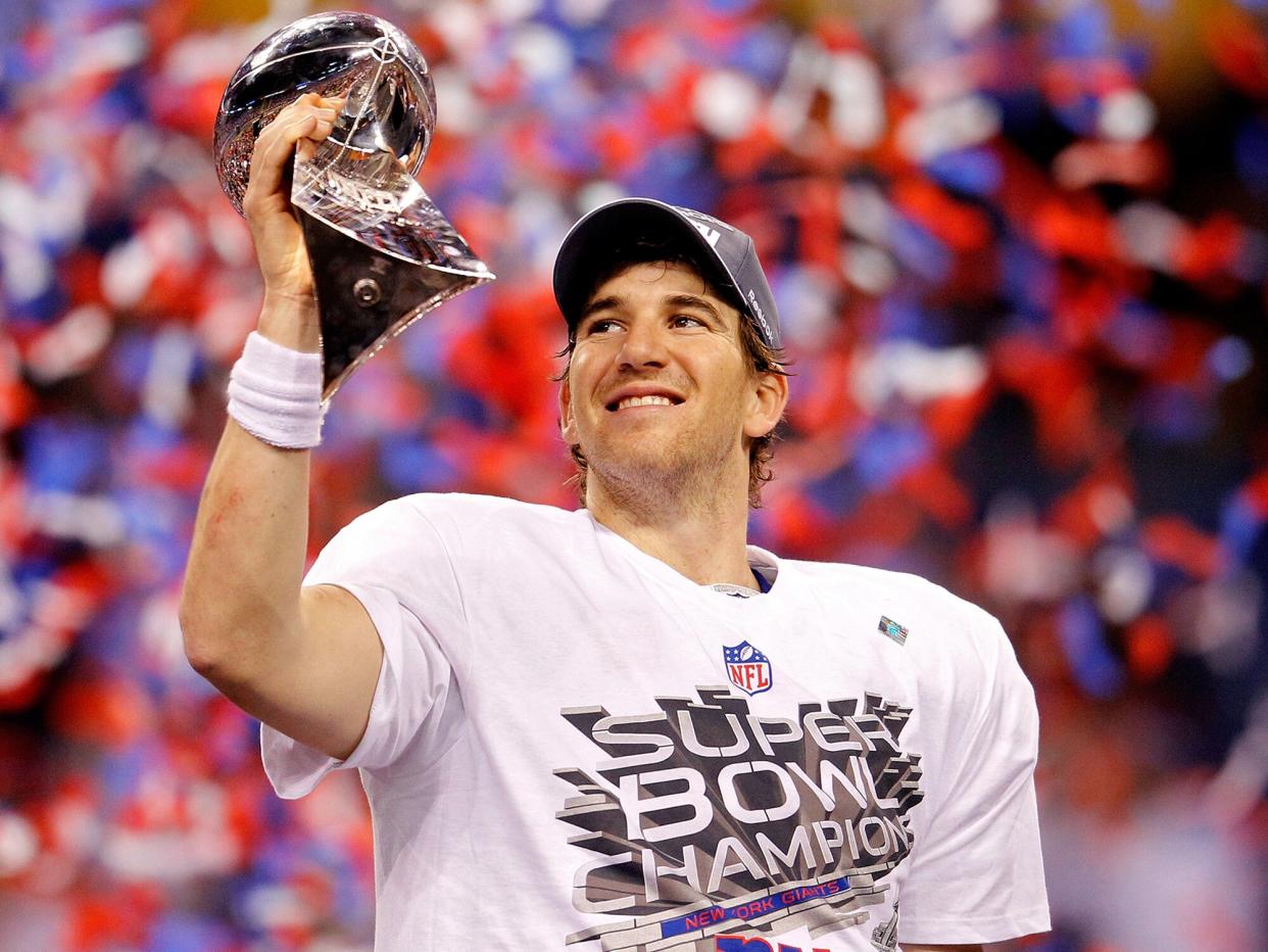 Eli Manning #10 of the New York Giants poses with the Vince Lombardi Trophy after the Giants defeated the Patriots by a score of 21-17 in Super Bowl XLVI at Lucas Oil Stadium on February 5, 2012 in Indianapolis, Indiana