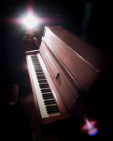 <p>Peter Jordan - PA Images/PA Images via Getty</p> A photo of John Legend's "Imagine" piano before it went up for auction in 2000.