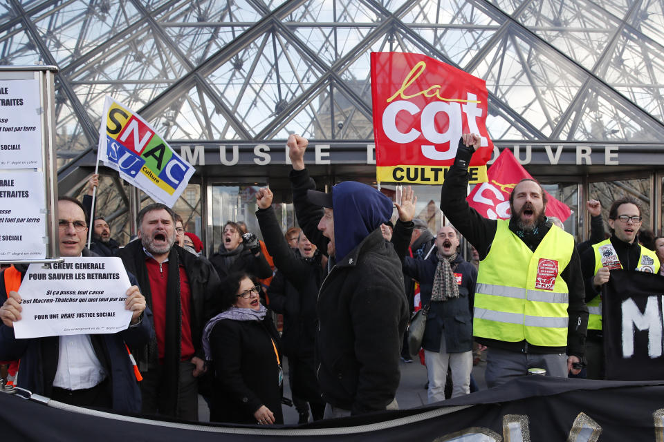 Striking employees demonstrate outside the Louvre museum Friday, Jan. 17, 2020 in Paris. Paris' Louvre museum was closed Friday as dozens of protesters blocked the entrance to denounce the French government's plans to overhaul the pension system. (AP Photo/Francois Mori)