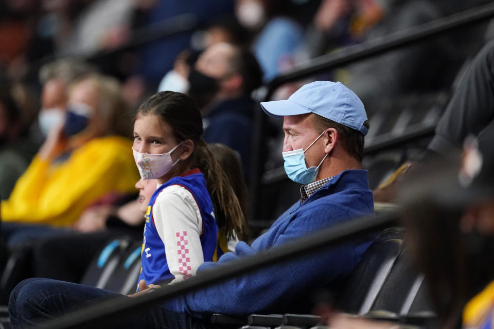 Retired Denver Broncos quarterback Peyton Manning looks on as the Memphis Grizzlies face the Denver Nuggets in the first half of an NBA basketball game Monday, April 19, 2021, in Denver. (AP Photo/David Zalubowski)