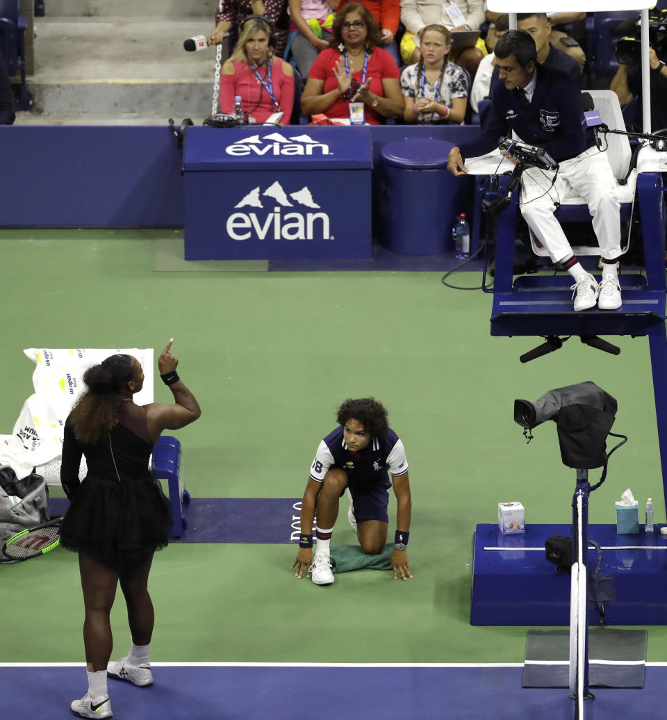 FILE - In this Sept. 8, 2018, file photo, Serena Williams, left, talks with chair umpire Carlos Ramos during the women's final of the U.S. Open tennis tournament against Naomi Osaka, of Japan, in New York. The indelible image from last year's U.S. Open does not involve anyone holding a trophy or making a particularly remarkable shot. It will be Williams pointing a finger at Ramos as she insisted he owed her an apology. (AP Photo/Seth Wenig, File)