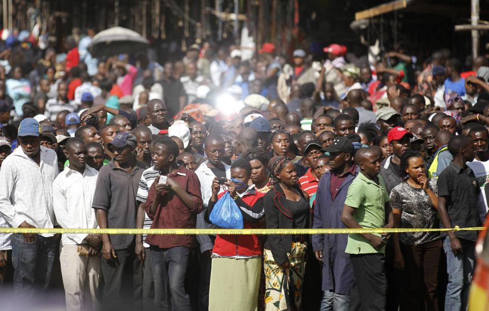 Second-hand clothes traders gather at the scene of a twin explosion at the Gikomba open-air market in Kenya's capital Nairobi May 16, 2014. (REUTERS/Thomas Mukoya)