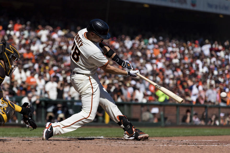 San Francisco Giants' Buster Posey hits a two-run single against the San Diego Padres in the fourth inning of a baseball game in San Francisco, Sunday, Oct. 3, 2021. (AP Photo/John Hefti)