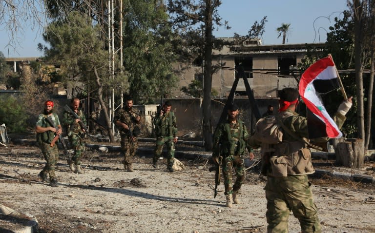 Syrian pro-government soldiers patrol the Uwaija neighborhood as they advance in Aleppo's rebel-held areas, on October 8, 2016