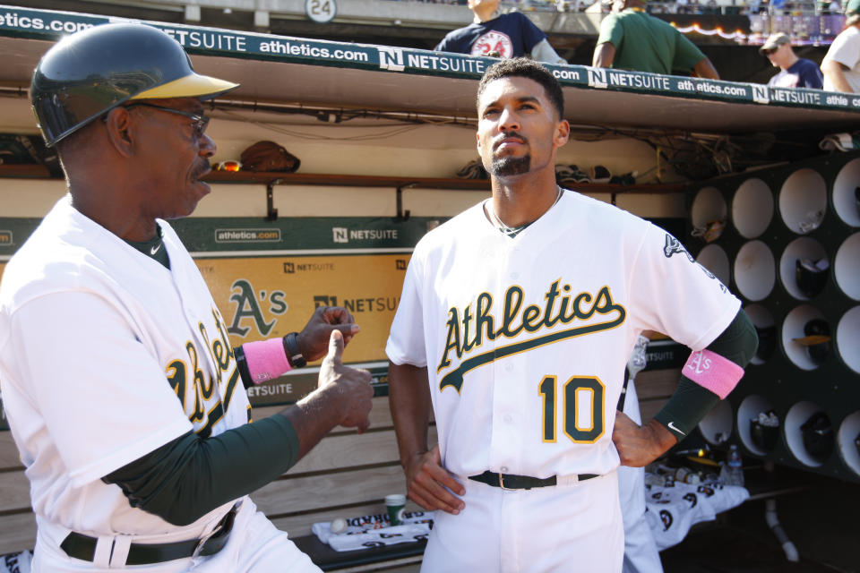 OAKLAND, CA - SEPTEMBER 4: Third Base Coach Ron Washington #38 and Marcus Semien #10 of the Oakland Athletics talk in the dugout during the game against the Boston Red Sox at the Oakland Coliseum on September 4, 2016 in Oakland, California. The Athletics defeated the Red Sox 1-0. (Photo by Michael Zagaris/Oakland Athletics/Getty Images) 