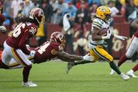 Sep 23, 2018; Landover, MD, USA; Green Bay Packers running back Aaron Jones (33) carries the ball past Washington Redskins linebacker Mason Foster (54) in the third quarter at FedEx Field. The Redskins won 31-17. Mandatory Credit: Geoff Burke-USA TODAY Sports