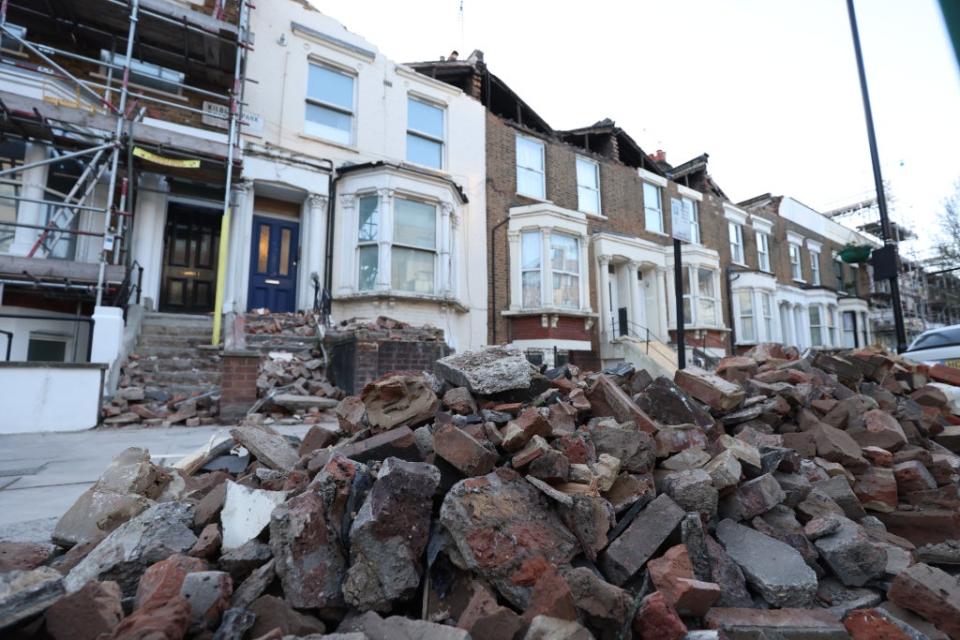 A roadside filled with debris from the rooftops of three houses in London which were torn off during the storm (James Manning/PA) (PA Wire)