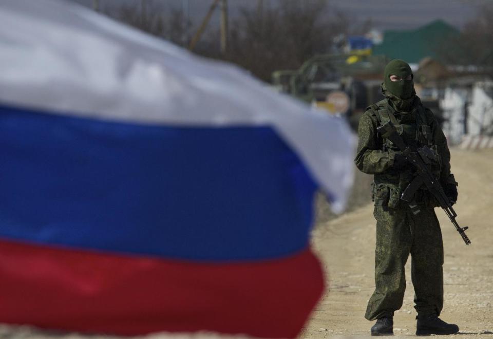 Pro-Russian soldiers block the Ukrainian naval base in the village of Novoozerne, some 91 km west of Crimean capital Simferopol, Ukraine, on Monday, March 3, 2014. Ukraine says Russian forces controlling the strategic region of Crimea are demanding that the crew of two Ukrainian warships in Sevastopol's harbor must surrender. (AP Photo/Ivan Sekretarev)